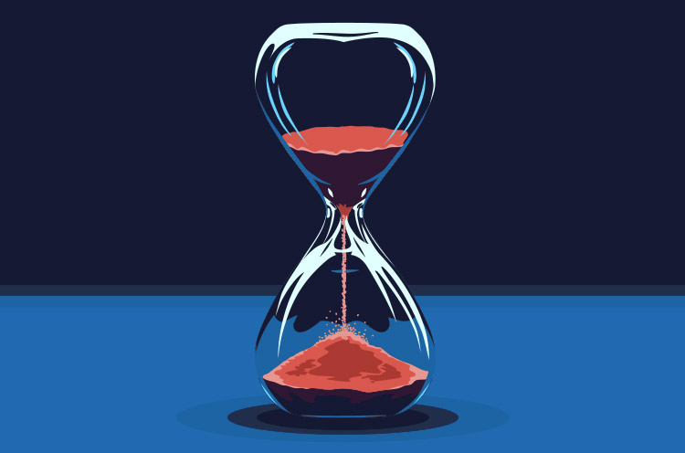 A glass hourglass with red sand flowing from the upper chamber into the lower chamber against a dark blue background.