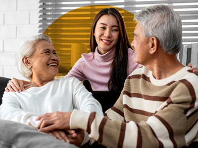 A woman reassuring her parents